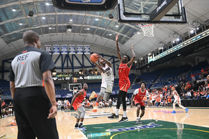 Dwight Buckys Jr. (pictured, No. 23) drives inside for a layup. Boeheim's Army outscored Team Gibson 60-36 in the paint.