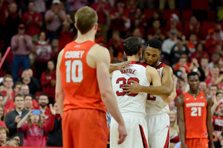 NCSU's Staats Battle hugs a teammate after hitting a late 3.