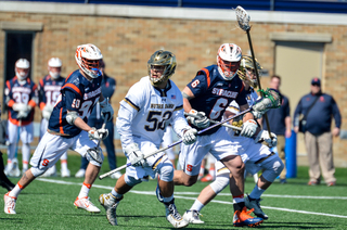 Garrett Epple gets in front of two Syracuse players. 