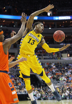 Vander Blue #13 of the Marquette Golden Eagles reaches for the ball in the game aginast the Syracuse Orange.