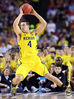  Mitch McGary #4 of the Michigan Wolverines prepares to pass the ball against the Syracuse Orange.