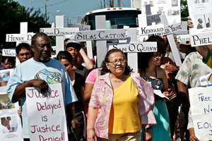 (From left) Diane Nash and John Steele march in Philadelphia, commemorating the 49th anniversary of the deaths of several civil rights leaders, whose names are written on the cross.