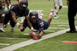 Cornerback Brandon Reddish and linebacker Cameron Lynch dive for a loose ball along the sideline during Syracuse's 17-16 loss to Pittsburgh.