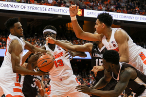 Syracuse players scramble for a ball against St. Bonaventure. The Orange defense played tough and held the Hokies to 61 percent of its scoring average coming into the game. 