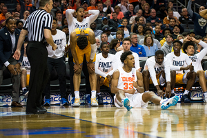 Elijah Hughes celebrates on the floor after a made basket.