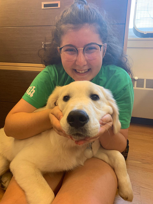 Maddie Jones poses with Copernicus, her service dog.