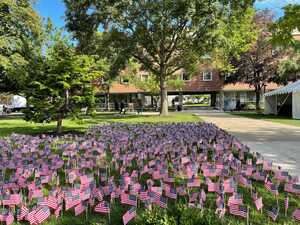 After the solemn service concluded with music and speeches, the audience filled the grass nearby Hendricks Chapel with American flags.