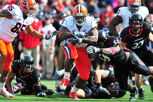 Delone Carter rushes for a few of his game-high 113 yards rushing Saturday. Carter and quarterback Ryan Nassib led an offensive attack that controlled the ball against the Bearcats.