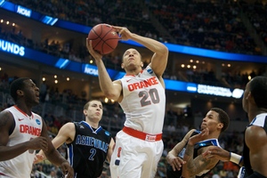 Guard Brandon Triche goes in for a layup amid UNC Asheville defenders during Syracuse's 72-65 win over UNC Asheville. Triche added nine points, three assists and three rebounds. Syracuse played without its starting center, Fab Melo, after he was ruled ineligible by the university.