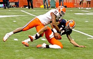 Brandon Sharpe (91) sacks quarterback John Kinder (14) in Saturday's Spring Game.