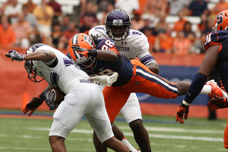 Safety Jeremi Wilkes (28) makes a flying tackle.  