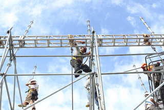 Workers are seen assembling scaffolding to hold video screens aboard the USS Midway Museum on Nov. 8, 2012, before the Battle on the Midway game between the Syracuse Orange and the San Diego State Aztecs scheduled for Sunday.