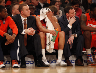 Michael Carter-Williams cools off while watching the game from the bench.