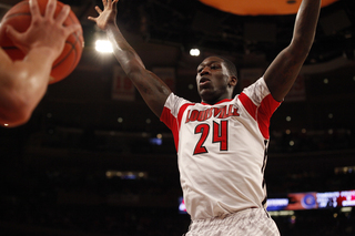 Louisville's Montrezl Harrell (#24) defends against Triche in the paint.