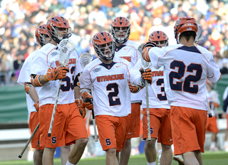 Kevin Rice runs toward captain JoJo Marasco. Marasco keyed the SU attack with five points.