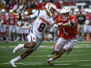 Hakeem Lecky braces himself against a Cornell check while preparing to dodge into the alley. 