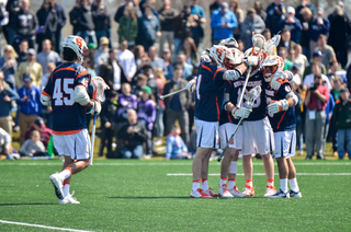 Syracuse players celebrate a goal. 