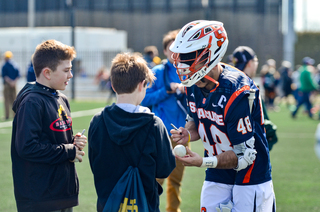 Salcido interacts with two young UND fans. 