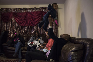 Cubahiro tosses his niece into the air. The family enjoys some down time, telling jokes and stories until 2 a.m. 