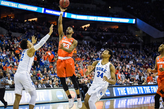 Syracuse junior point guard Frank Howard tries a floater in the lane.